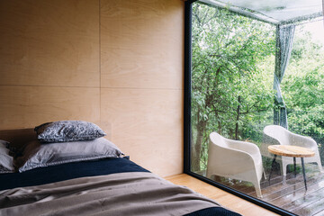 Cozy hotel bedroom with modern decor and views of nature