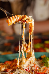 Delicious Italian Pasta with Stretchy Cheese and Fresh Ingredients