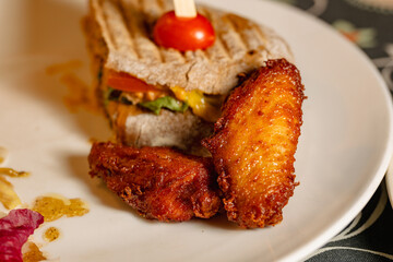 Delicious Sandwich with Fried Chicken Wings and Fresh Ingredients