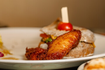 Delicious Fried Chicken Wings Served with Bread and Cherry Tomatoes, a Perfect Combination of Crunchy and Soft Textures