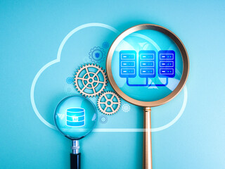 AI Data center, cloud computing management, digital infrastructure concept. AI data center icon and database symbol in magnifying glass, working inside cloud storage shape, on minimal blue background.