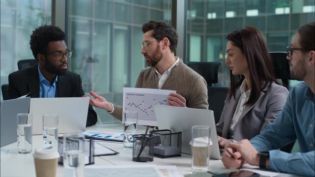 Caucasian leader analysis data graph report talking speaker statistics paper document multiracial colleagues business team diverse businesswomen businessmen meeting strategy plan presentation office - Powered by Adobe