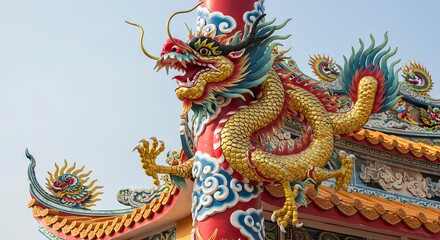 Fototapeta premium A colorful Chinese dragon statue wraps around a red pillar on a traditional roof against a clear sky