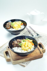 Yakiniku, grilled beef meats topped on a bowl of rice with vegetables, in the local restaurant Jakarta