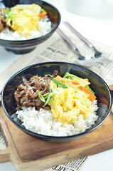 Yakiniku, grilled beef meats topped on a bowl of rice with vegetables, in the local restaurant Jakarta
