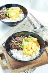 Yakiniku, grilled beef meats topped on a bowl of rice with vegetables, in the local restaurant Jakarta