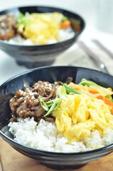 Yakiniku, grilled beef meats topped on a bowl of rice with vegetables, in the local restaurant Jakarta