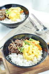 Yakiniku, grilled beef meats topped on a bowl of rice with vegetables, in the local restaurant Jakarta