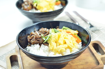 Yakiniku, grilled beef meats topped on a bowl of rice with vegetables, in the local restaurant Jakarta