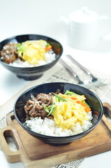 Yakiniku, grilled beef meats topped on a bowl of rice with vegetables, in the local restaurant Jakarta