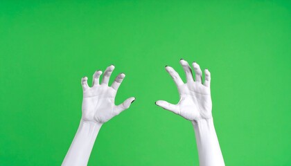 White hands reaching upward against green background