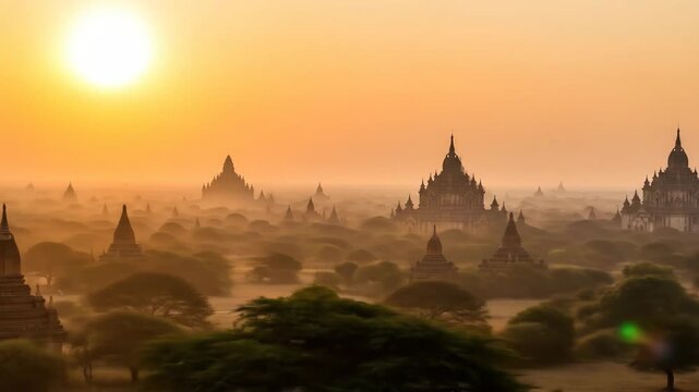 Sunrise Over Bagan Temples, Myanmar - A breathtaking panoramic view of the ancient Bagan temples in Myanmar at sunrise. Mist hangs in the air, shrouding many of the temples in a mystical golden light.