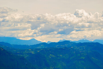 Dramatic cloudscape over the majestic and peaceful landscape of the green Colombian Andes mountain range, a beautiful and serene natural background from the coffee region of South America