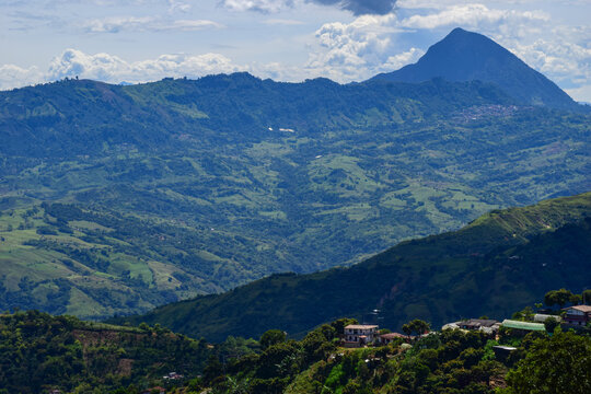 Breathtaking panoramic landscape of the Suroeste Antioque&ntilde;o (Southwestern Antioquia) coffee region in Colombia, featuring the iconic Cerro Tusa mountain peak, green valleys, and a blue sky with clouds