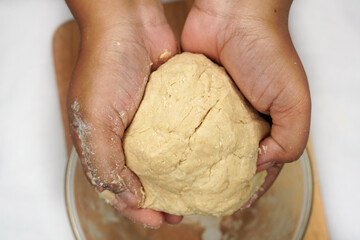 Making dough by female hands at bakery. Food concept. Hands dough. Female hands making dough for pizza. Chef in professional kitchen prepares dough.
