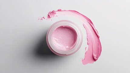 Pink cream in jar with smear on white background, beauty product