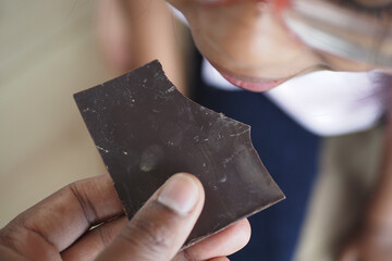 Child tasting chocolate in a casual indoor setting