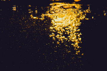 Abstract blurred golden bokeh lights against a dark background, creating a warm and festive...