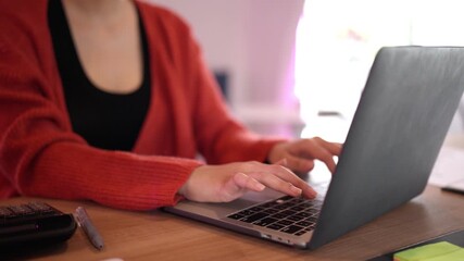 Adult professional female remotely working on laptop computer typing for online business management from home office setup - Powered by Adobe