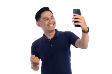 Excited young Asian man taking a selfie with smartphone and cheering isolated on transparent background