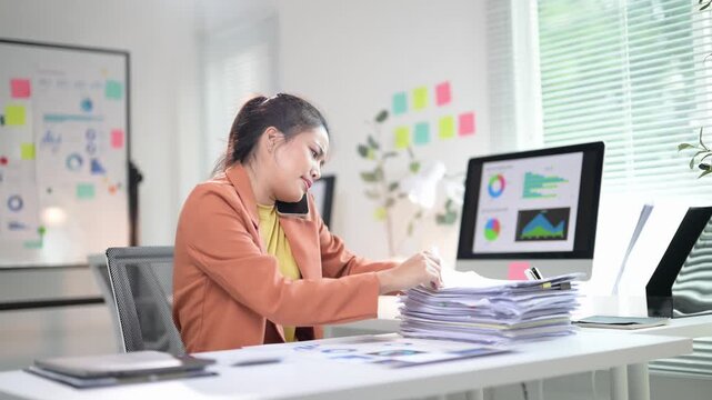 Businesswoman searching information in documents while calling