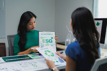 Businesswomen discussing environmental, social, and governance - esg - in office meeting