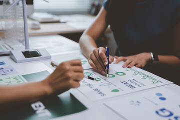 Businesswomen planning sustainable business strategies using green energy