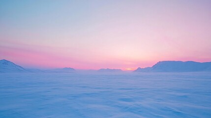 Fototapeta premium Arctic landscape with snow and mountains under a colorful sunrise sky