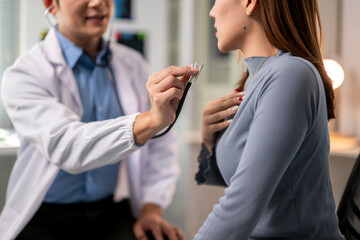 doctor is examining a woman's chest