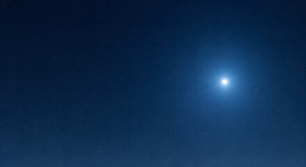 Fototapeta premium Bright blue light source illuminating a dark night sky.