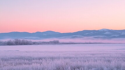 Obraz premium Frozen Field and Distant Mountains at Dawn with Pink and Blue Sky