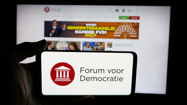 Stuttgart, Germany - 07-10-2025: Person holding cellphone with logo of Dutch party Forum voor Democratie (FvD) on screen in front of webpage. Focus on phone display.
