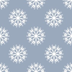 Seamless pattern with elegant white lace-like floral motifs on a soft blue-grey background, perfect for textiles, digital art, and decorative designs.