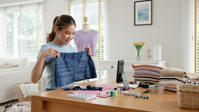 Asia people go green woman selfie live video vlog talk online teach make craft DIY eco second hand idea reuse old used fabric net zero waste fast fashion issue. Asian design hobby thrift retail store.