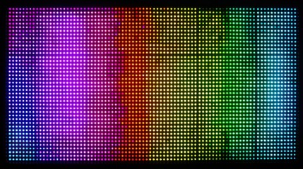 A dazzling LED screen illuminates the evening with a smooth gradient of colors ranging from purple to green. This lively display enhances the ambiance of the urban atmosphere.