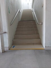 Indoor Staircase with Handrails and Safety Arrow in Building