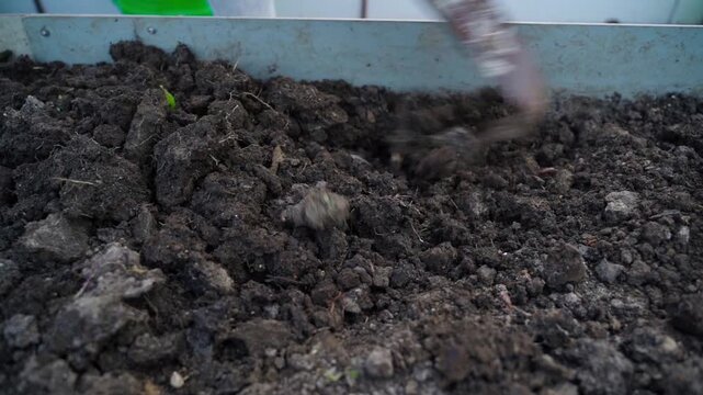 Close-up of soil piled up in a garden bed in slow motion