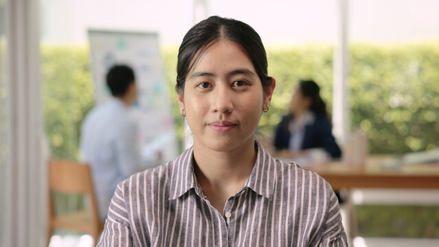 The way forward save the planet earth Gen Z female asia people go green net zero waste ESG office desk. Portrait headshot face young adult woman asian SDGs auditor work look at camera smile happy.
