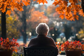 Elderly woman sitting outdoors on a terrace on a sunny autumn day, reflecting tranquility and the joys of outdoor living during the fall season, Generative AI