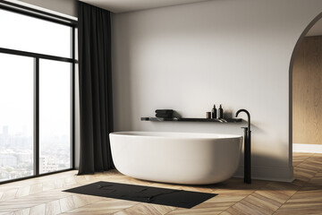 Modern minimalist bathroom interior with white bathtub and city view through large window, black fixtures and cozy wooden floor design. 3D Rendering
