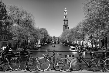 Bikes on the bridge that crosses the canal in Amsterdam, Netherlands (black & white)