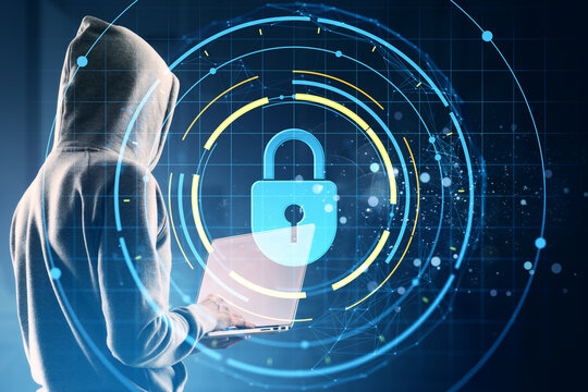 Hacker in hoodie using laptop with digital holographic padlock symbol representing cybersecurity and data protection on virtual background. - Powered by Adobe