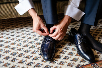 Groom preparing for wedding day in elegant attire