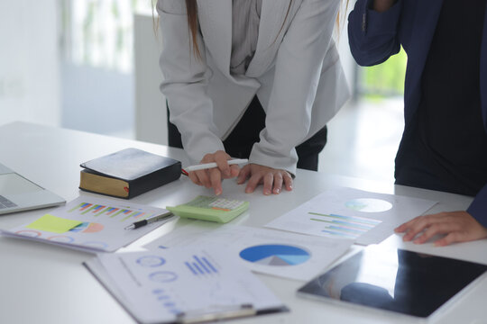 Teamwork of business people brainstorming with financial data graph analysis on the table in the meeting room.