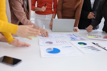 Teamwork of business people brainstorming with financial data graph analysis on the table in the...