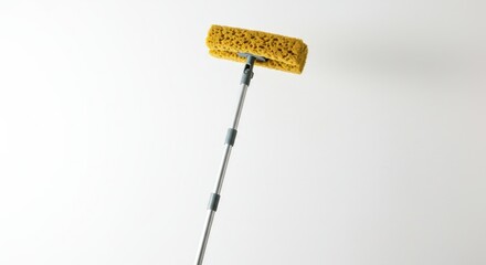 Yellow cleaning brush on extendable pole