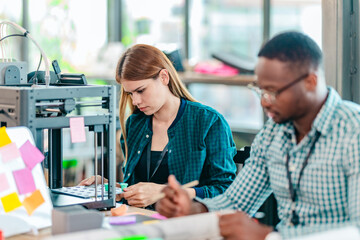 Obraz premium Diverse Startup Team Working on 3D Printing Project