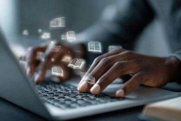Close-up of dark-skinned hands typing on a laptop with book icons hovering