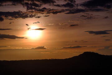 orange twilight sunset sky over green  mountains scene
