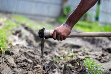 A worker working with iron tools in ash and clay